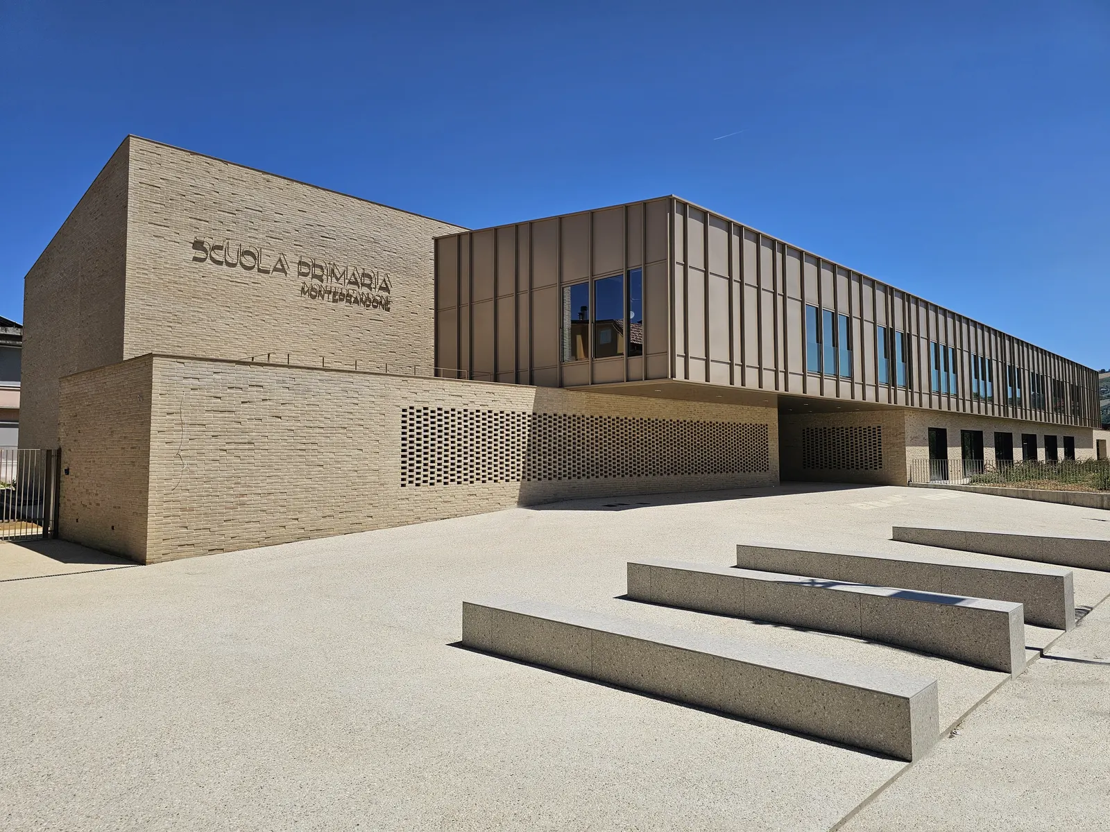 Brick facade and windows of the primary school in Centobuchi.