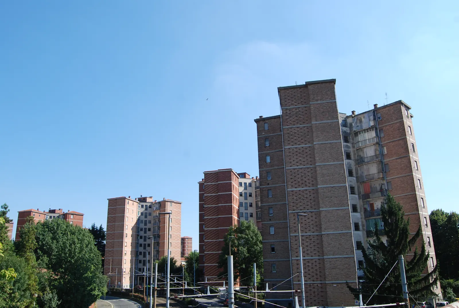 Residential towers in Turin’s Vallette neighbourhood beneath a blue sky