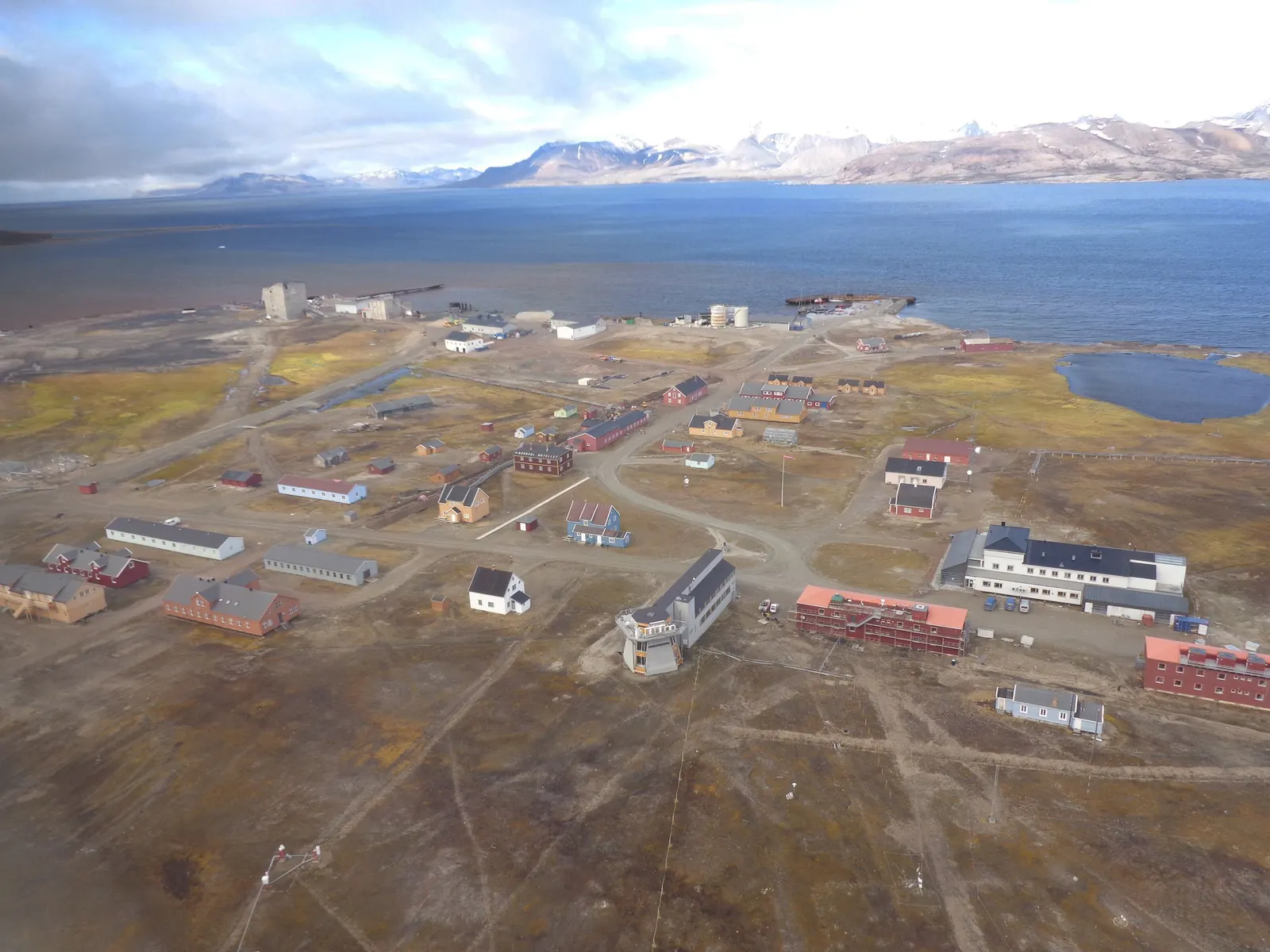 Aerial view of Ny-Ålesund’s buildings and the fjord in Svalbard.