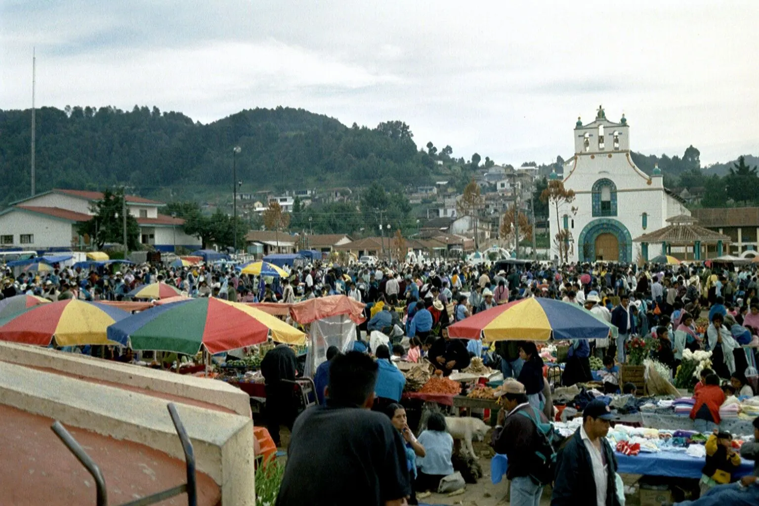 Market square in San Juan Chamula with colourful stalls and people, in a photograph from 2003.