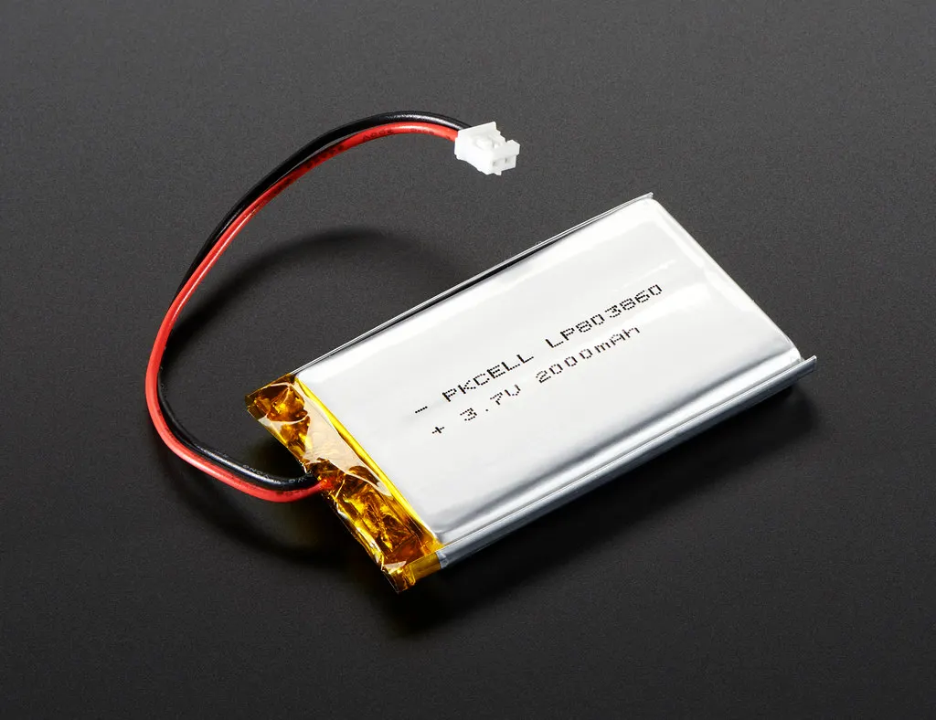 A lithium polymer battery in a silver pouch, with red and black wires