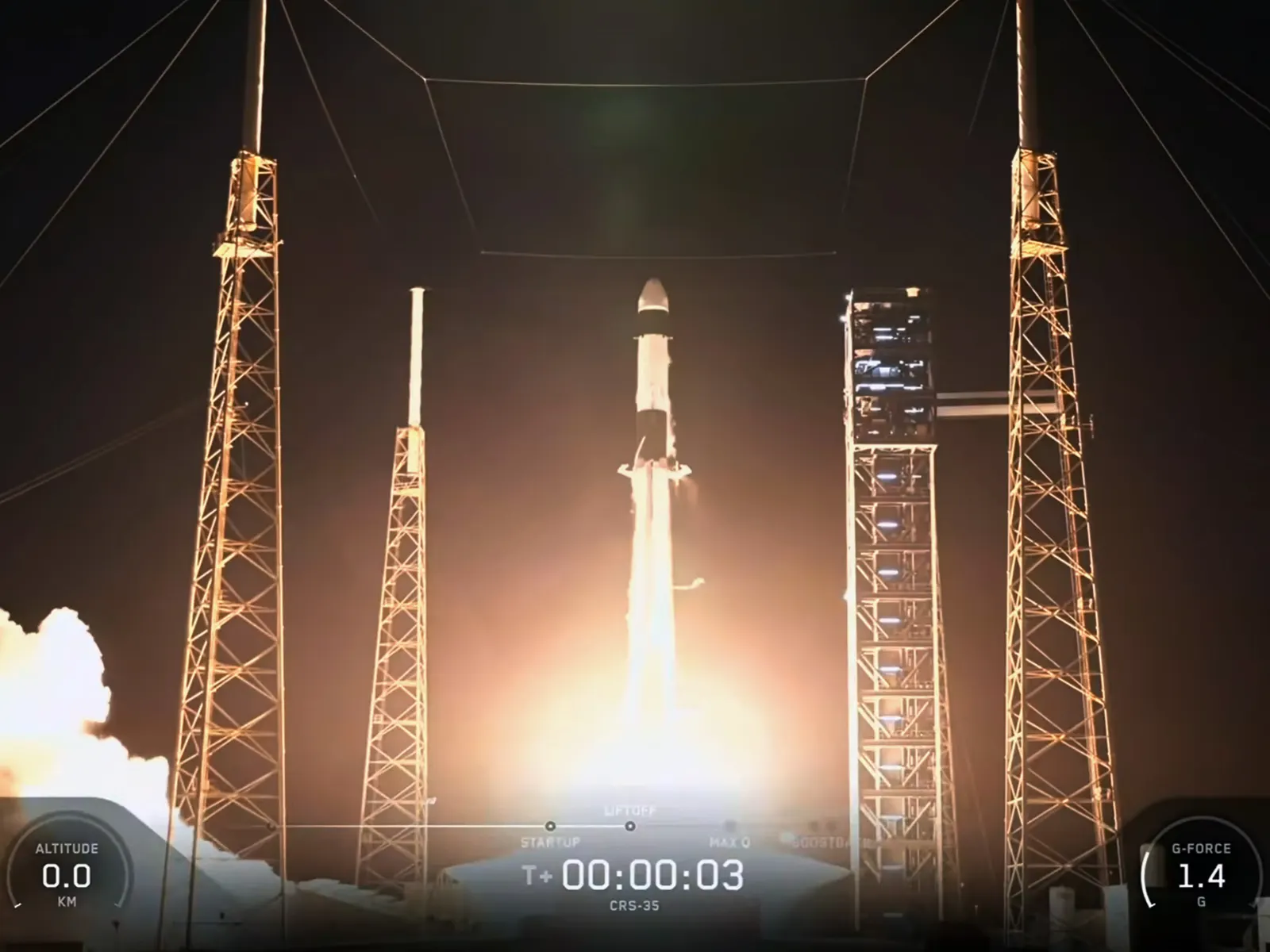Falcon 9 carrying Dragon rises from the illuminated pad during the night-time launch.