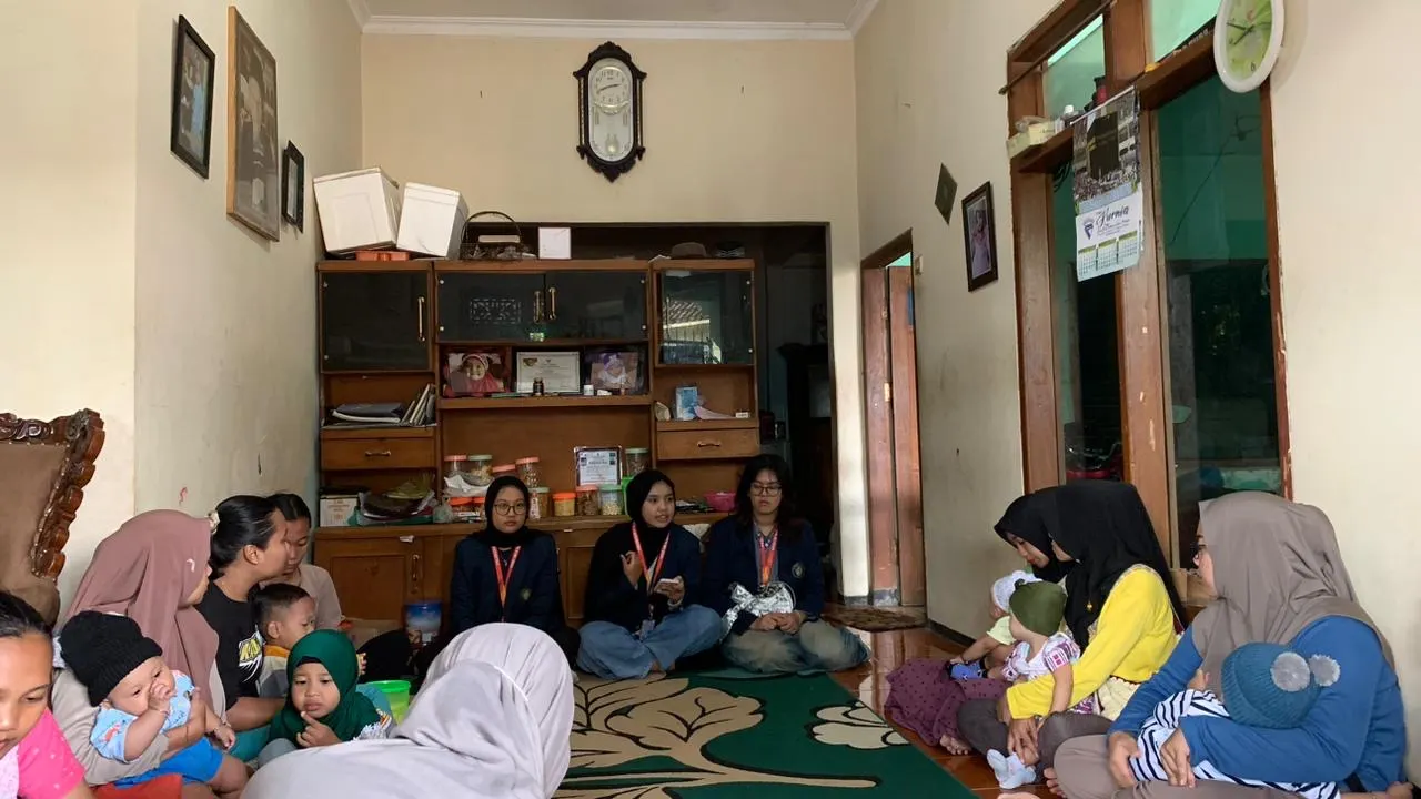 Mothers, children and health workers gather for health activities in a room in Benel, Indonesia.