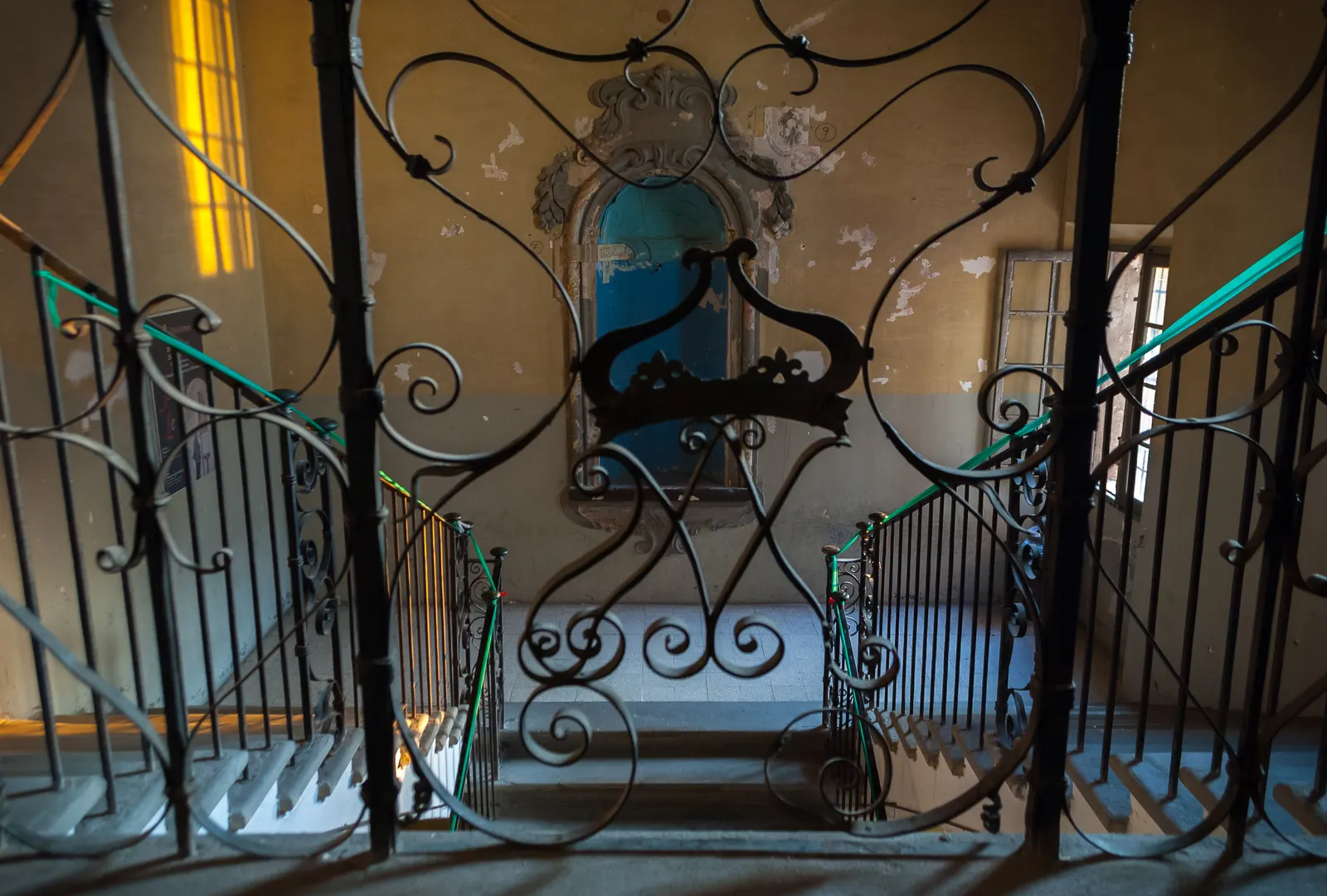 Interior staircase and iron railing at Palazzo delle Orsoline in Fidenza
