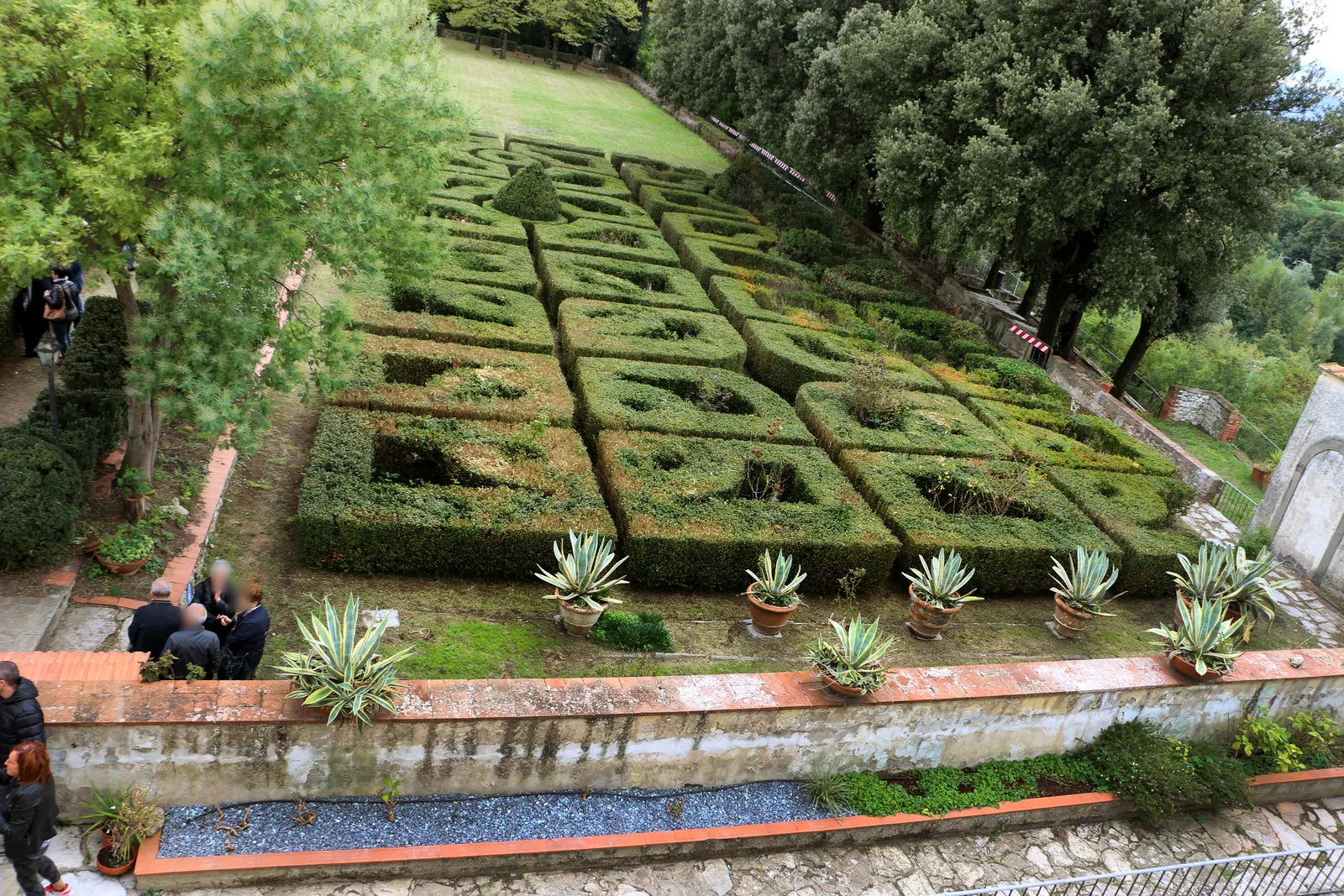 Villa del Palco’s formal Italian garden, with geometric hedges, trees and pots along the terrace
