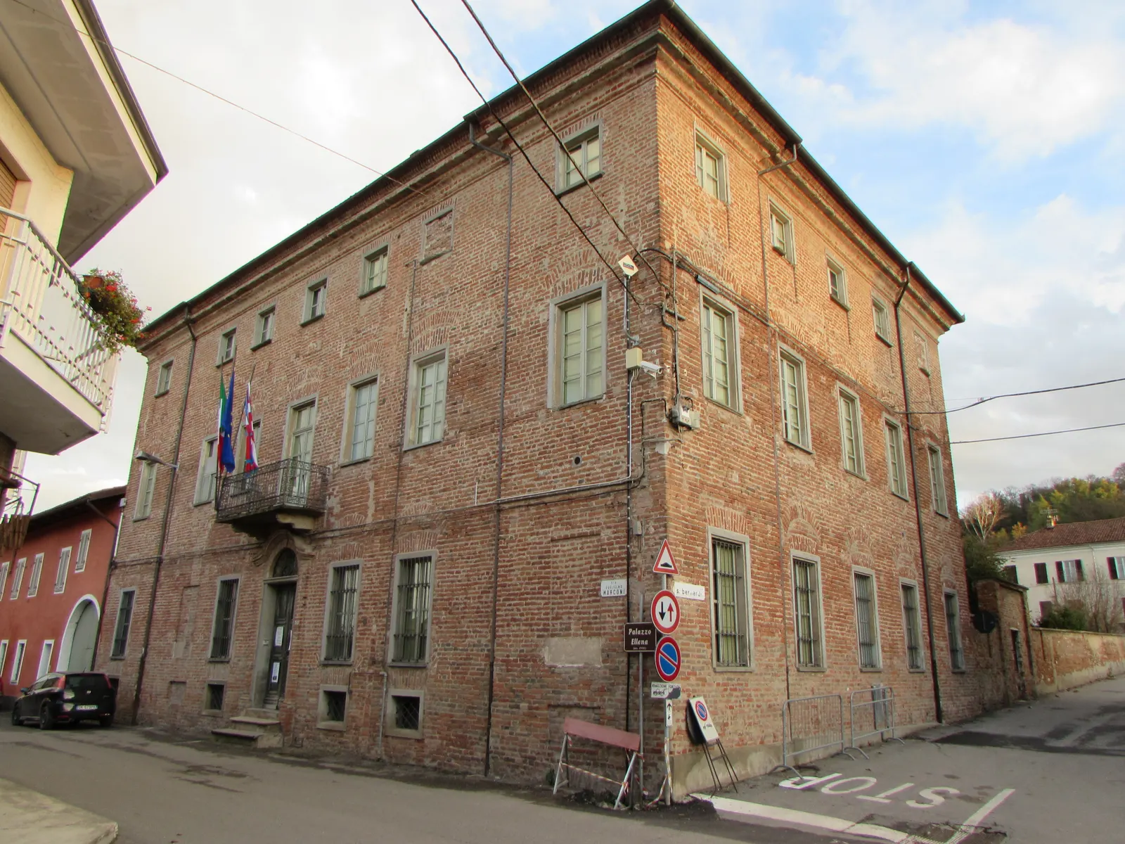 The brick exterior of Palazzo Ellena in Brusasco, seen from the street; archive photograph.
