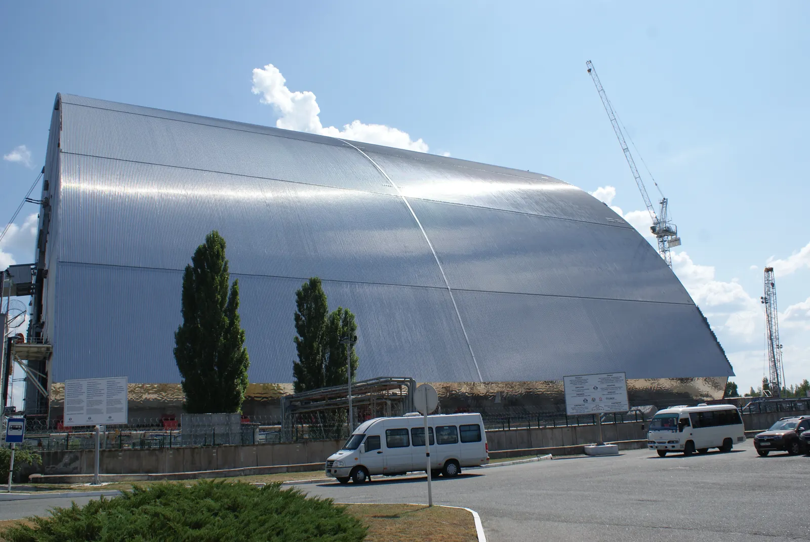 The New Safe Confinement’s large arched metal structure, with a crane beside it.