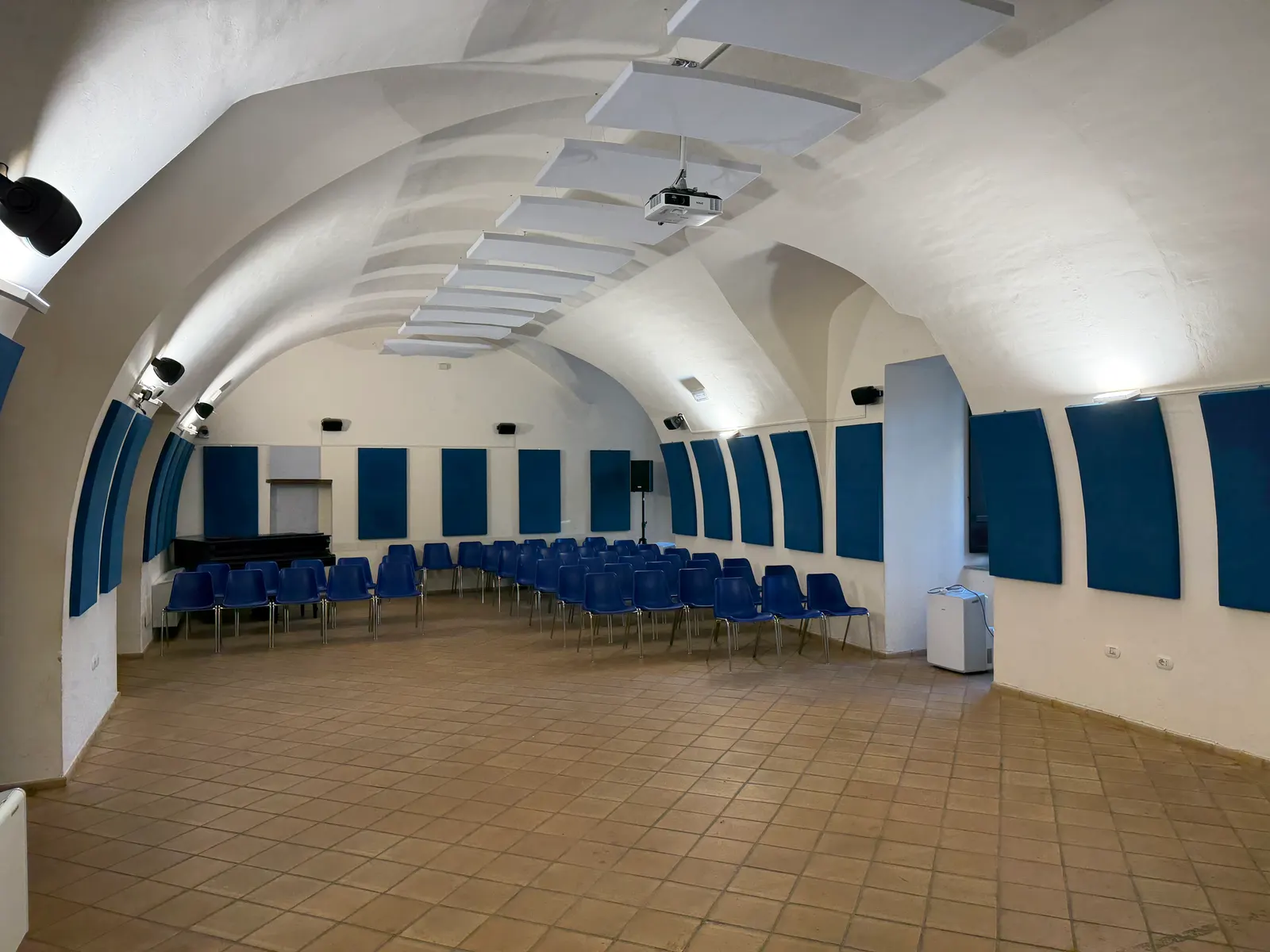 A vaulted room with chairs in the San Domenico complex in Lamezia Terme.