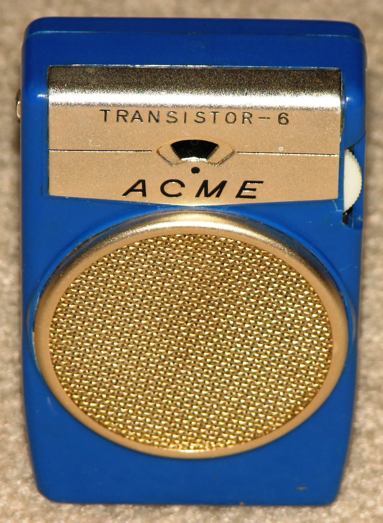A blue Acme portable radio with a gold-coloured panel and speaker grille.