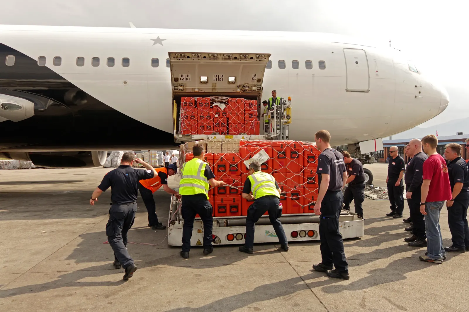 Workers unload large red crates from an aircraft in Kathmandu in a photograph from 2015.
