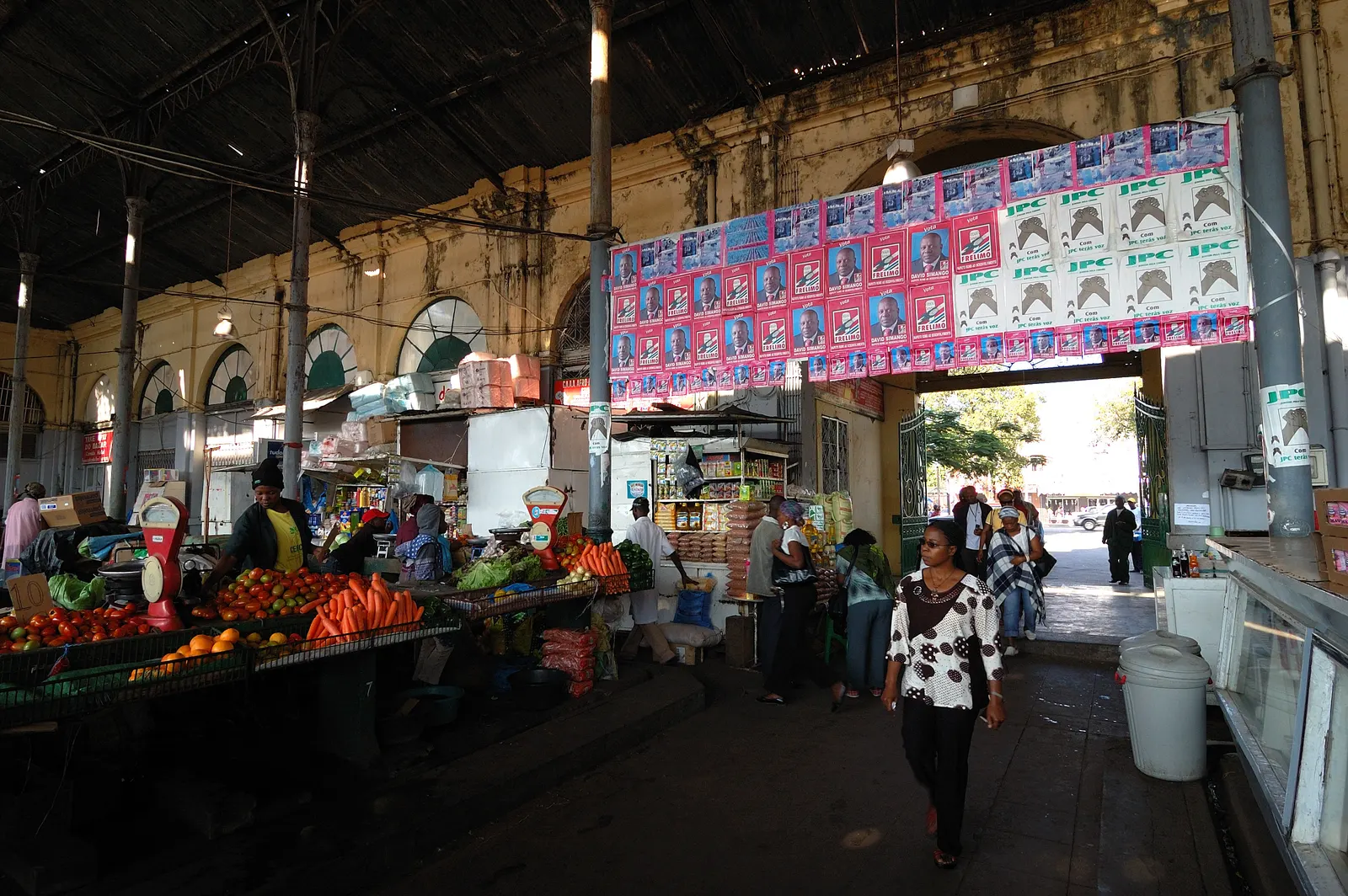 Fruit and vegetable stalls, sellers and customers inside Maputo’s municipal market