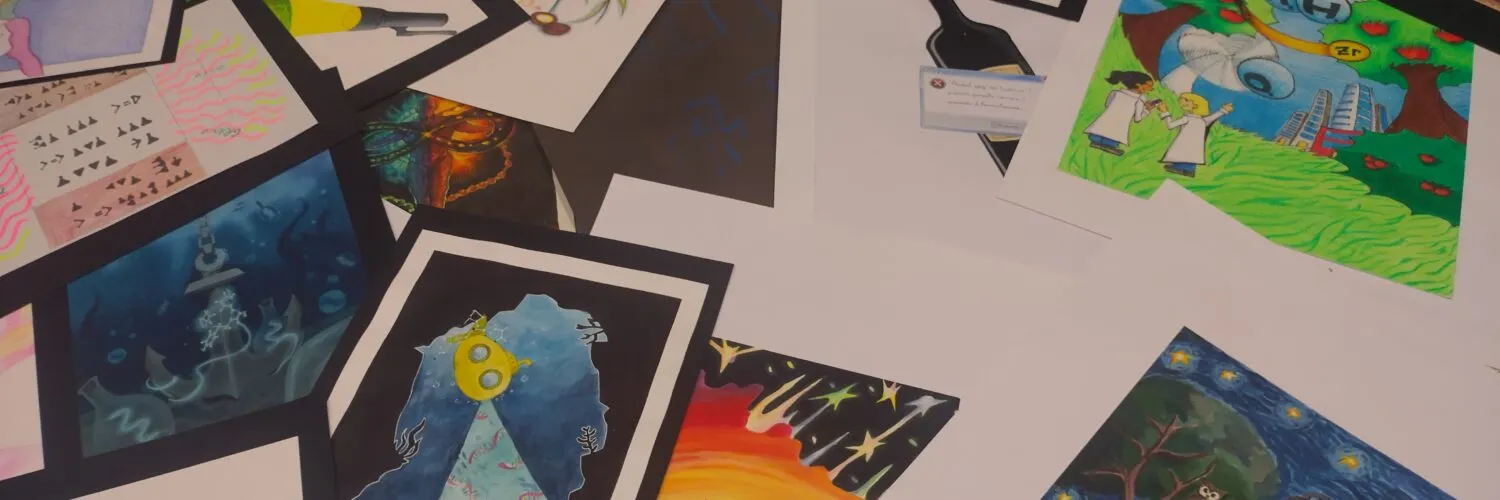 Students’ drawings about scientific subjects arranged on a table